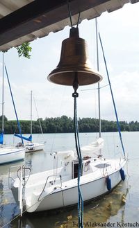 Sailboats moored in sea against sky