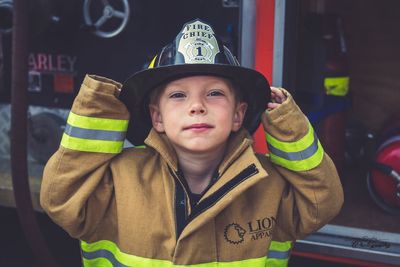 Portrait of boy wearing headwear while standing outdoors