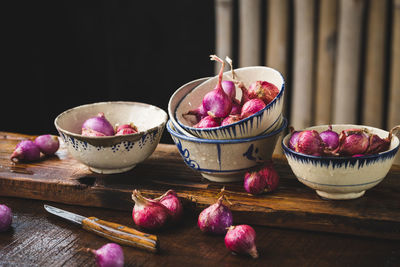 Fresh shallots-red onions on the dark background