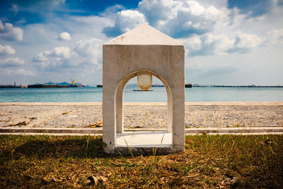 Built structure on beach against sky