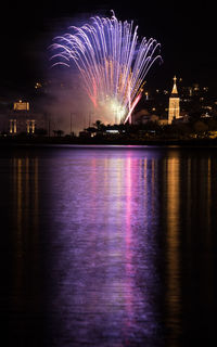 Firework display over city at night