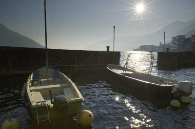 Boats in sea against sky in city