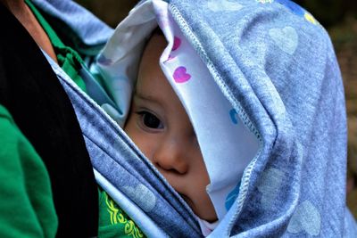 Midsection of father carrying daughter in baby carrier