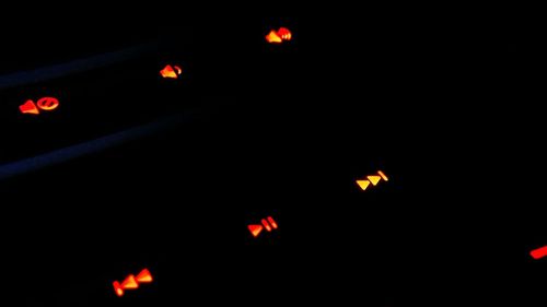 Low angle view of lit lights in the dark