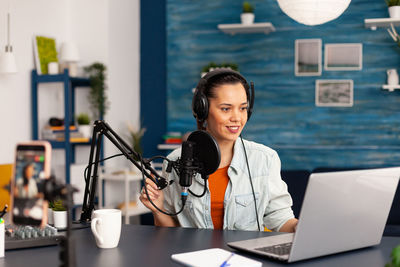 Young woman blogging at office