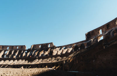 Low angle view of old ruin against clear blue sky