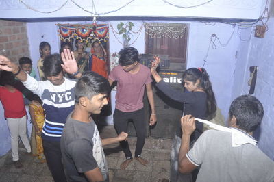 Rear view of people standing against the wall