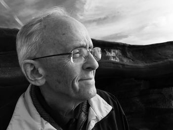 Close-up of senior man against mountains