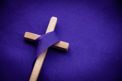 Religious cross on purple background. good friday concept
