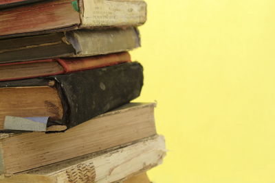 Close-up of stack of books against wall