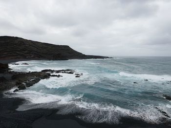 Scenic view of sea against cloudy sky