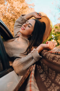 Portrait of young woman in car