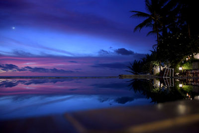 Scenic view of lake against sky at sunset