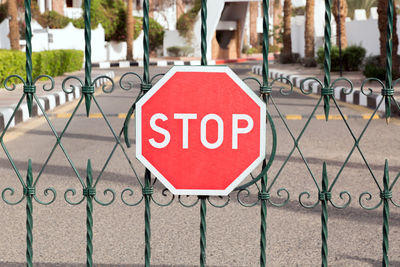 Closed gate with a red stop sign at the entrance to the hotel