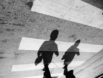 Shadow of people on road