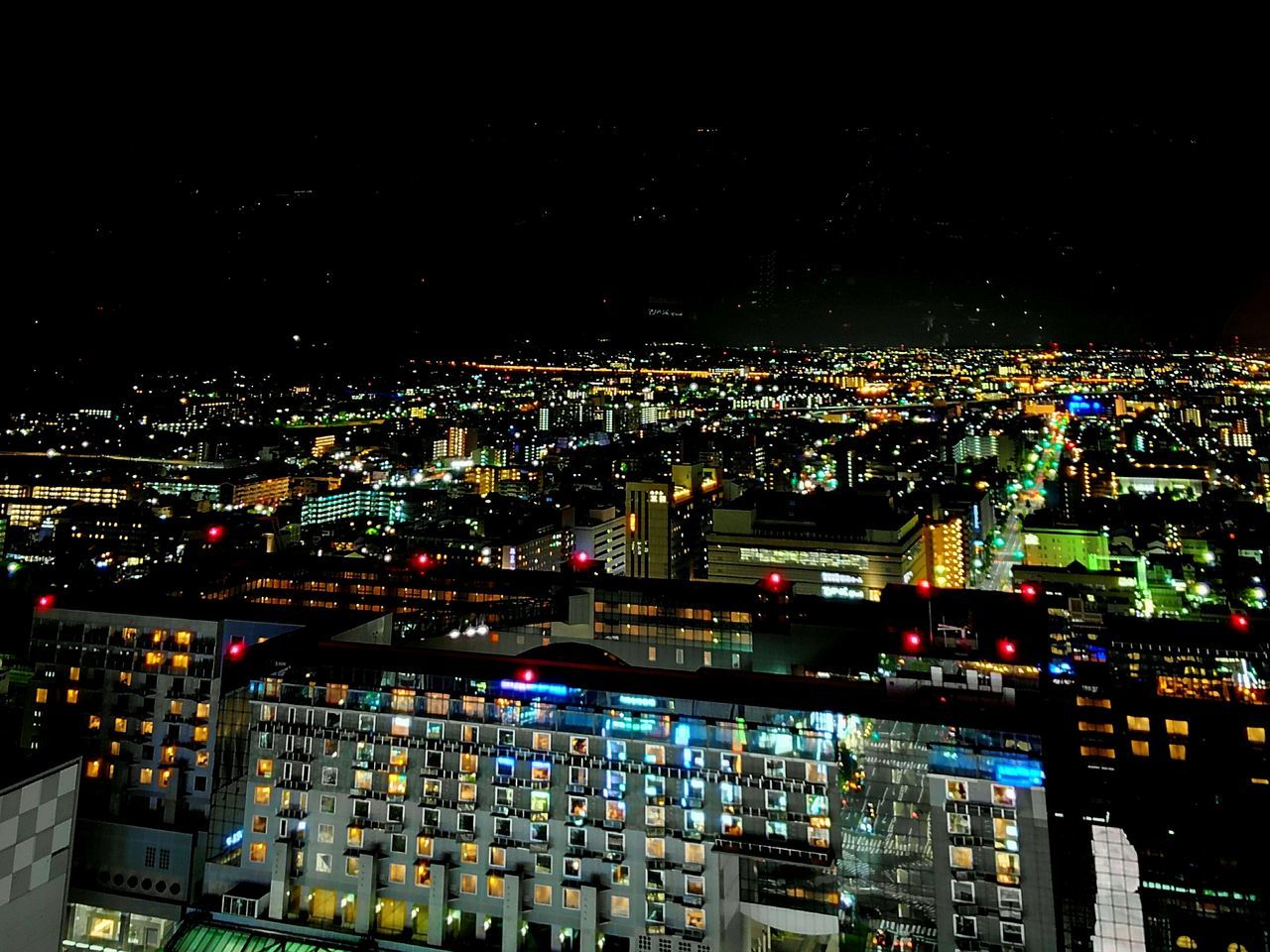illuminated, night, city, cityscape, architecture, building exterior, built structure, crowded, skyscraper, aerial view, travel destinations, sky, modern, city life, outdoors, development, tall - high, capital cities, multi colored, spire, no people, financial district, tourism
