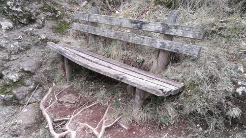 High angle view of abandoned bench on field