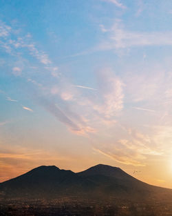 Scenic view of silhouette mountains against sky during sunset