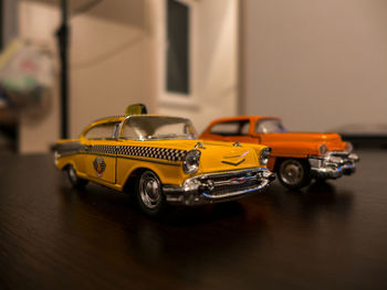 Close-up of yellow car on table