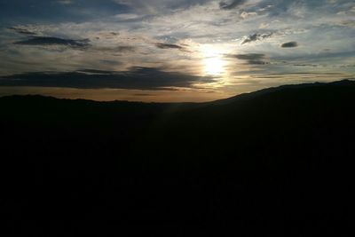 Scenic view of silhouette mountain against sky at sunset