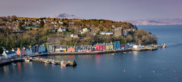 Panoramic view of sea and buildings against sky