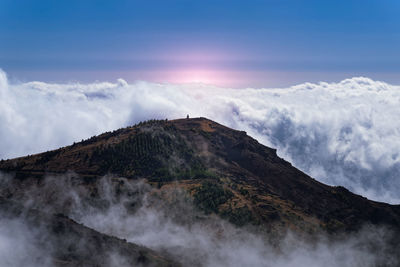 Low angle view of volcanic mountain against sky