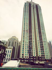 Low angle view of modern buildings in city against sky