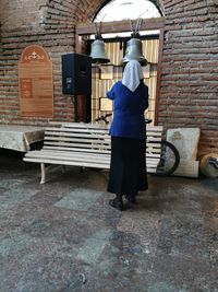 Rear view of woman ringing the bell