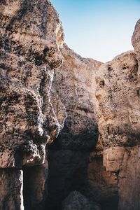 Low angle view of rock formations against clear sky