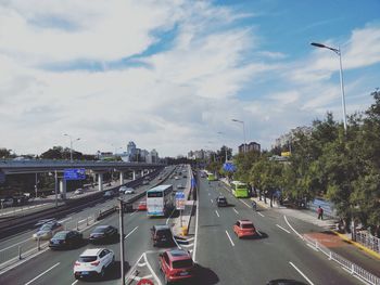 Traffic on road in city against sky