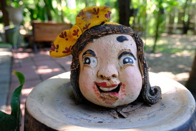 Close-up of buddha statue on table