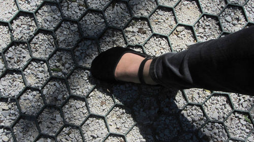 Low section of person standing on stone