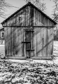 Old damaged building on field against sky