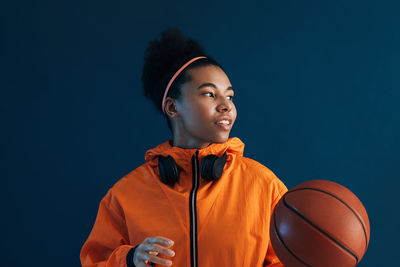 Side view of young man playing basketball