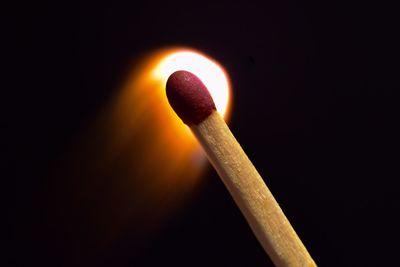 Close-up of illuminated lamp against black background