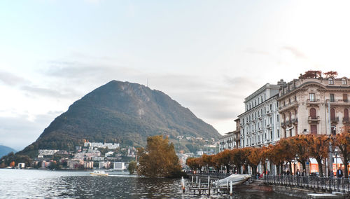 Join this wonderful in lugano during the late afternoon. buildings by mountains against sky in city. 