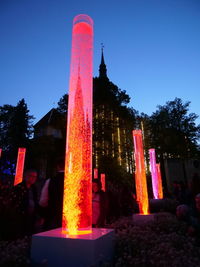 Illuminated built structure against clear sky at dusk