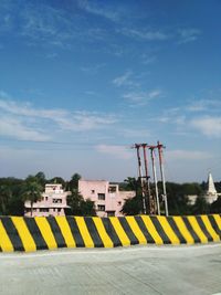 Yellow flag on built structure against sky