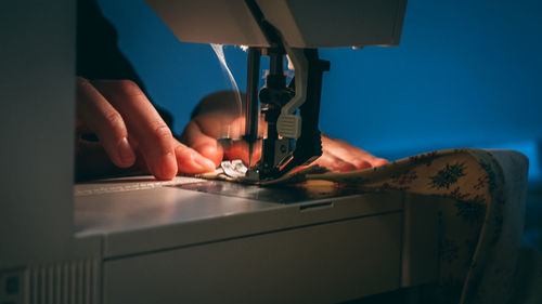 Close-up of man working on sewing machine