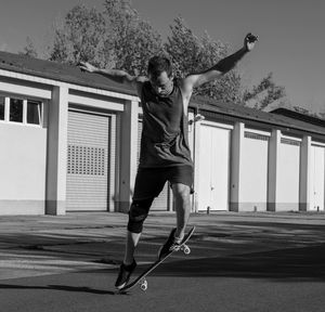 Full length of young man walking in front of building
