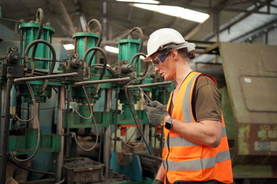 Rear view of man working in factory