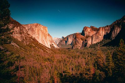 Panoramic sunset view over the forested valleys and mountains of yosemite national park