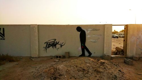 Man walking in front of building