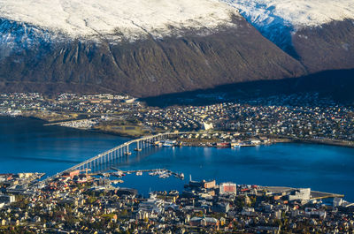High angle view of cityscape by sea against sky