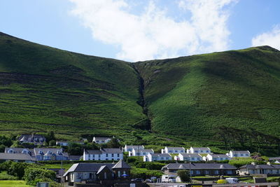 Houses on mountain against sky