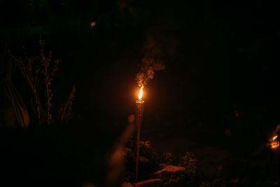 Illuminated street light against sky at night