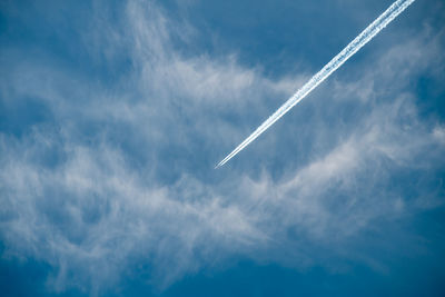 Low angle view of vapor trails in sky