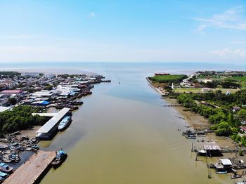 High angle view of buildings by sea against sky