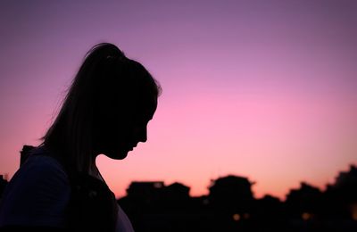 Side view of silhouette woman standing against clear sky