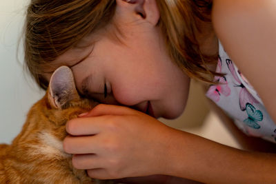 Close-up of cute girl with at cat